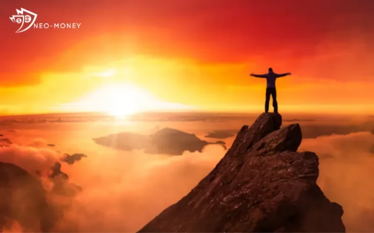 man standing on top of mountain at sunset for http://neo-money.com/ about page